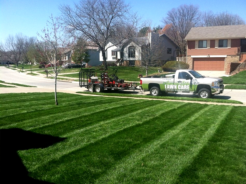 The Greener Side Lawn Care truck parked at mowing job in Omaha